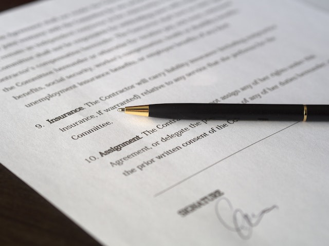 a lease document with a pen on top awaiting signature